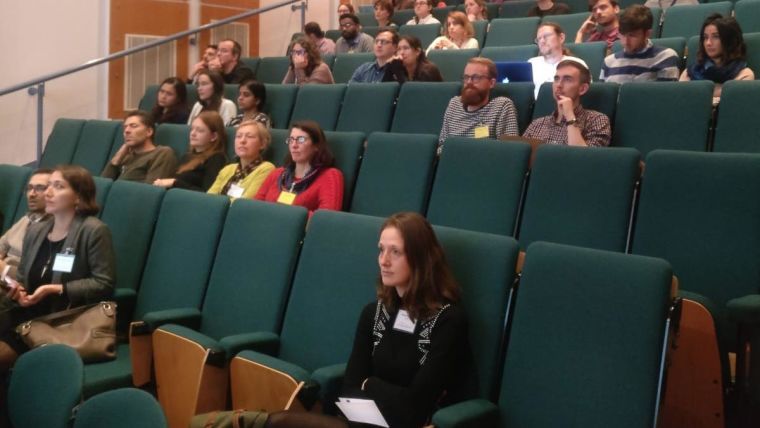 Postdocs sat in a lecture theatre watching the talks