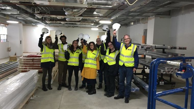 8 OPDC researchers including Director Richard Wade-Martins, Dayne Beccano-Kelly and Natalie Connor Robson hold hard hats 